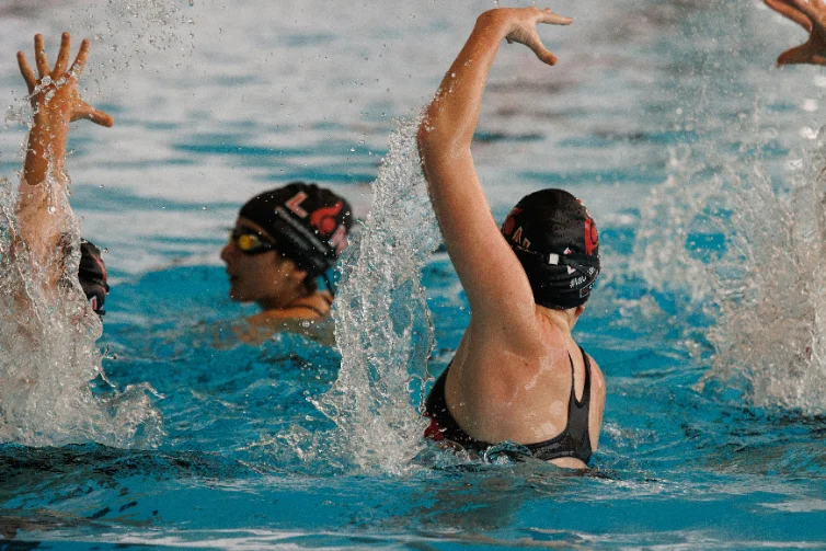 Artistic swimming team performing